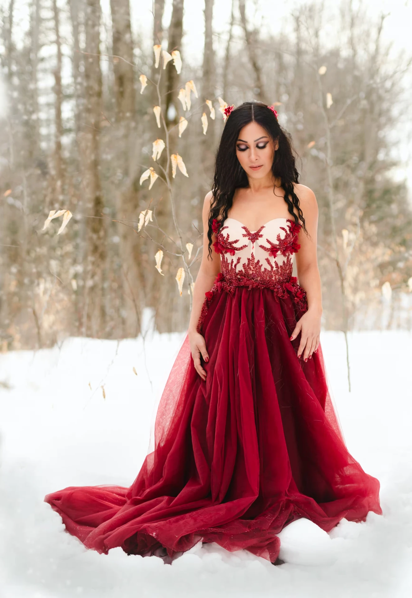 Melina Soochan in a feathered dark dress against a green backdrop