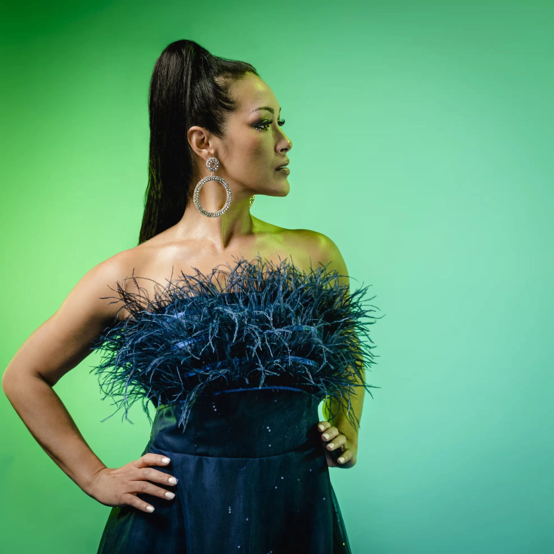 Melina Soochan in a dark dress against a vivid green backdrop