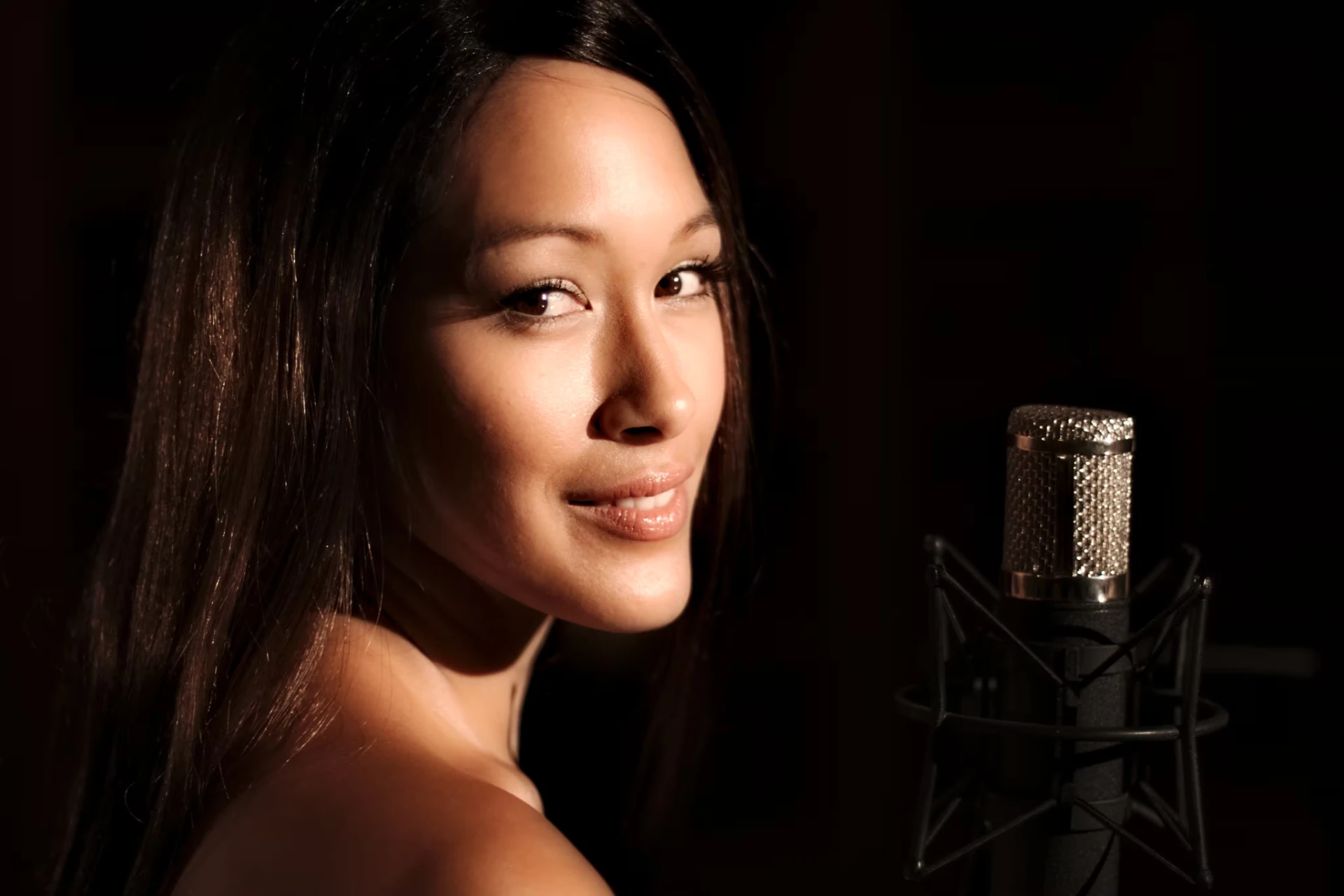 Melina Soochan beside a studio microphone